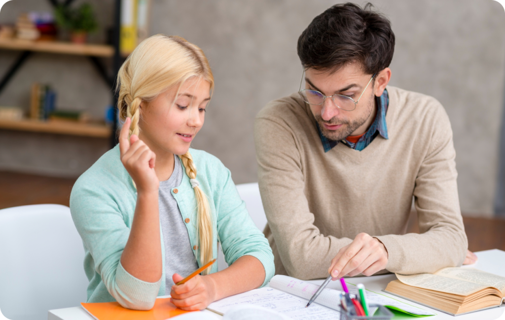 Tutor helping a teenage girl with her homework