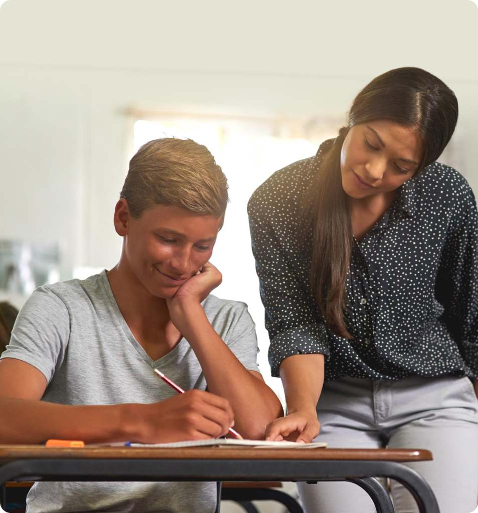 Counselor helping a student with a written assignment