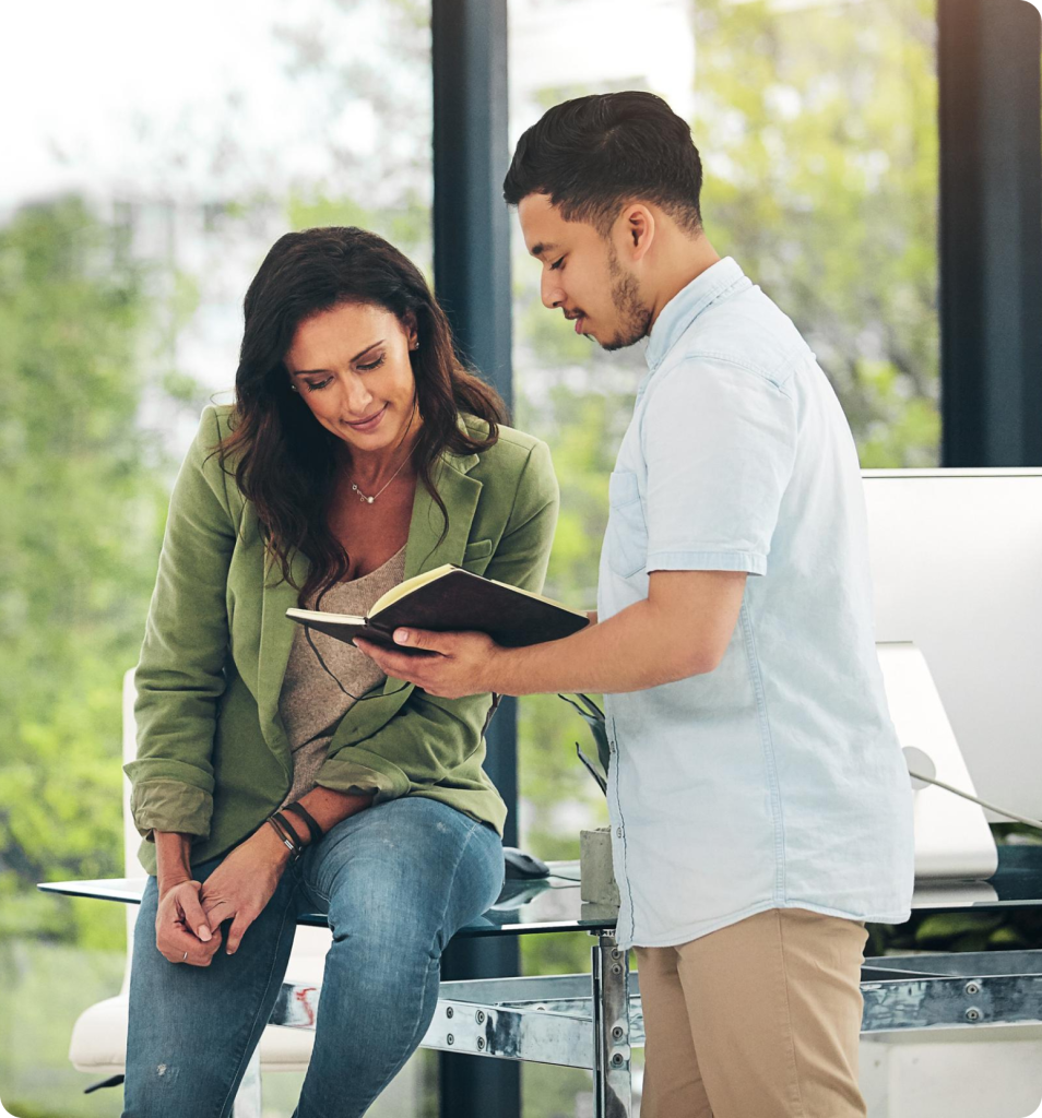 Counselor talking with a student holding a notebook