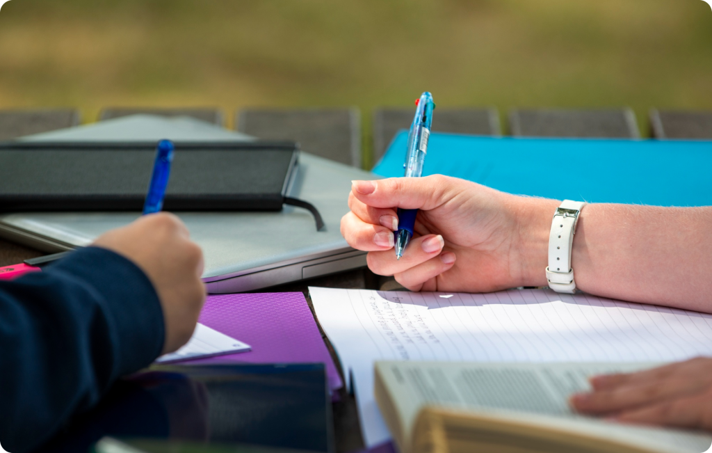 Close-up of hands filling out an application form